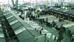 Crowd of travelers at airport terminal check-in area Stock Footage