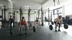 Crossfit team lifting weights in the gym Stock Footage