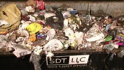 A dumpster overflows with trash. Stock Footage