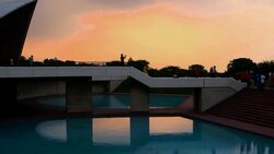 People taking photographs at the exit from the Lotus Temple, New Delhi at dusk Stock Footage