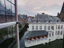 MS Window opens onto canal/ Bruges, Flanders, Belgium Stock Footage