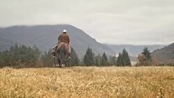 SLO MO Cowboy riding a galloping horse in the mountains Stock Footage