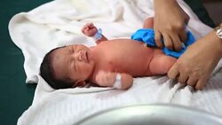 Footage of the one-day-old newborn baby showers Stock Footage