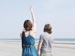  MS SLO MO Young couple flying kite at beach / Isle of Palms, South Carolina, USA Stock Footage