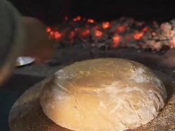 HD: Putting Yeast Dough In Brick Oven Stock Footage