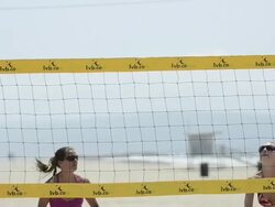 CU of female beach volleyball players spiking and blocking at the net and digging. Stock Footage