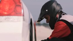 Stock car pit-crewman removes race-car lug-nuts Stock Footage