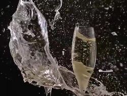 MS SLO MO Shot of Glasses of champagne breaking and splashing against black background / Calvados, Normandy, france Stock Footage