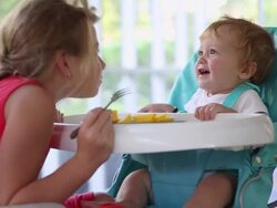 MS Shot of young girl feeding her baby brother / St Simon's Island, Georgia, United States Stock Footage