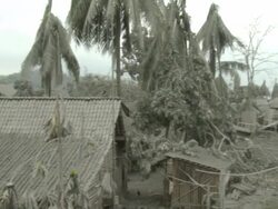 Pan across village and river devastated by heavy volcanic Ashfall from Merapi volcano; Indonesia. 7 November 2010 / AUDIO Stock Footage