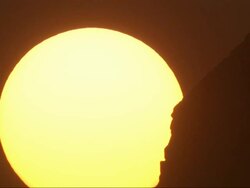 Close Up, static  - The sun glows as it rises behind a pyramid / Egypt Stock Footage