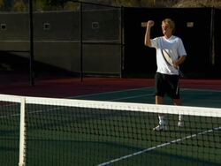 WS, PAN, Two young men shaking hands above tennis net, Santa Barbara, California, USA Stock Footage