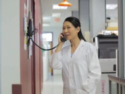 MS POV Female technician answers phone at research center / Vancouver, BC, Canada Stock Footage