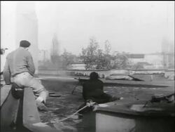 B/W 1956 REAR VIEW person in black coat fires machine gun / Hungarian uprising Stock Footage