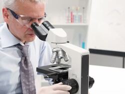 HD: Senior Male Scientist Working With Microscope Stock Footage
