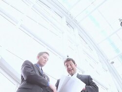  LA Businessmen examining blueprints and gesturing / Seattle, Washington, United States Stock Footage