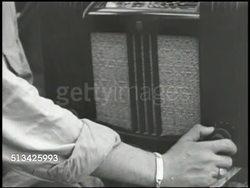 1943: BOUGAINVILLE CAMPAIGN: VS U.S. soldiers relaxing outdoors on camp, smoking cigarette, talking, listening to radio (Radio Tokyo, SOT), soldier laughing. WWII, World War II, Pacific Front, base Instructional Video