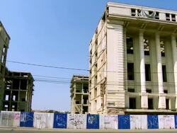 MS PAN Cars moving on street in front of old historic abandoned building / Bucharest, Romania Stock Footage