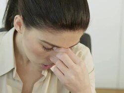 CU woman holding head in hands, desperate, crying, mumbling something Stock Footage
