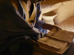A man reading poetry in the library of Chinguetti Stock Footage