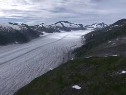 'Wide Shot aerial-Glacier fills wide canyon in Alaska. / Alaska, USA' Stock Footage