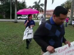 Long tracking shot of protesters marching with banners and chanting Immigration Activists Protest Outside Of Marco Rubio Fundraiser at Biltmore Hotel on April 05, 2013 in Miami, Florida (Footage by Getty Images)Immigration Activists Protest Outside Of Marc Stock Footage