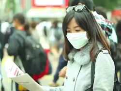 HD:Asian woman wearing a mask standing in a big city. Stock Footage