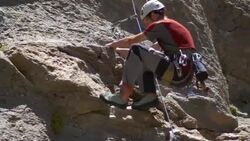 A young man rock climbing on a mountain. Stock Footage