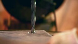 Drilling through metal plate. Stock Footage