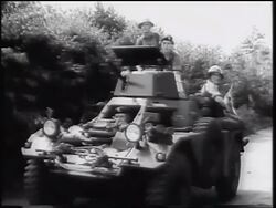 B/W 1961 British soldiers sitting on small tank with trees + bushes in background / West Germany / Cold War Stock Footage
