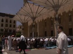 Tilt down to many people, bowing in prayer outside, Islamic area of Cairo, Egypt (sound available) Stock Footage