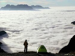 HA Camper looking out at sea of clouds in the mountains / Italy Stock Footage