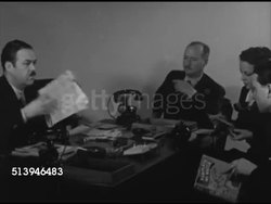 1939: TIME & LIFE PARIS OFFICE: MCU Typewriter typing. VS Time Life office in Paris, France, INT staff editors in meeting, various workers handling questions (from New York), male on telephone, switchboard operator. Fact checking, news correspondents Instructional Video