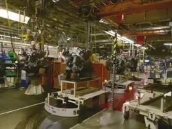 MS T/L Man transfers engines from automated carriages in an auto assembly plant / Princeton, Indiana, United States Stock Footage