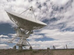 Medium zoom-in - A giant satellite dish slowly rotates as it performs astronomy research / New Mexico, USA Stock Footage