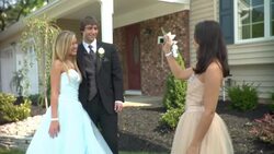 MS, Teenage girl (16-17) photographing couple in prom attire in front of house, Edison, New Jersey, USA Stock Footage