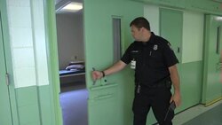 Prison officer opening empty cell News Clip
