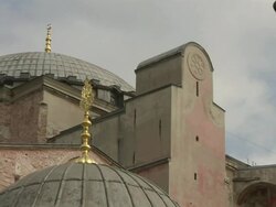 Low Angle pan-left - Golden spires top the domes of Hagia Sophia. / Istanbul, Turkey Stock Footage