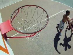 POV HA WS of basketball court, backboard, rim and net with white and black men dribbling, playing and shooting the ball. Stock Footage