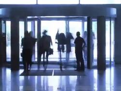 People moves through revolving door Stock Footage