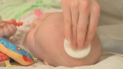 moisturizing baby's skin on head Stock Footage