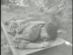 1950: KOREAN WAR: BATTLE OF TAEGU: * VS Wounded United States Marines, one lying facedown on stretcher, soldiers carrying wounded on stretchers down hillside, soldiers walking w/ wounded. South Korea, 38th Parallel Instructional Video