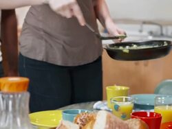 HD: Woman Serving Scrambled Eggs Stock Footage