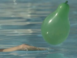 High Speed Balloon burst in swimming pool, Spain. Stock Footage