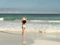 Woman standing at water's edge Stock Footage