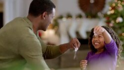 Happy father and daughter sprinkle flour on cookie dough (dolly-shot) Stock Footage