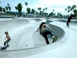 WS SLO MO Shot of two skateboarders doing front side air spin in and out of skate park bowl and rail slide / Venice, California, United States Stock Footage