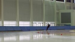 MS SLO MO Male long track speed skater practicing on ice in arena Stock Footage