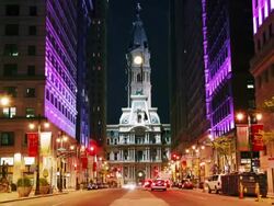 Time lapse, night time, city street with Philadelphia City Hall Building in background. Stock Footage