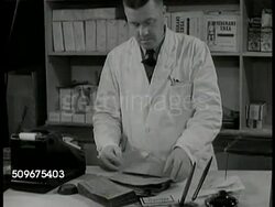 1943: SWEDEN: APARTMENTS: WS Children playing in sand box w/ apartments BG. HA WS Apartment houses. Government sponsored. PRIVATE ENTERPRISE: HA PAN Factory. DOLLY PAST Workers in chocolate factory. Instructional Video